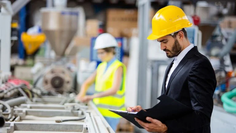 Inspector reviewing manufacturing quality at a factory